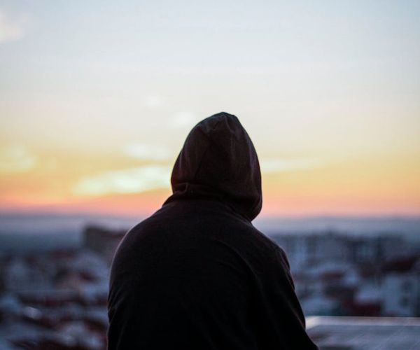Person meditating peacefully in a minimalist setting.